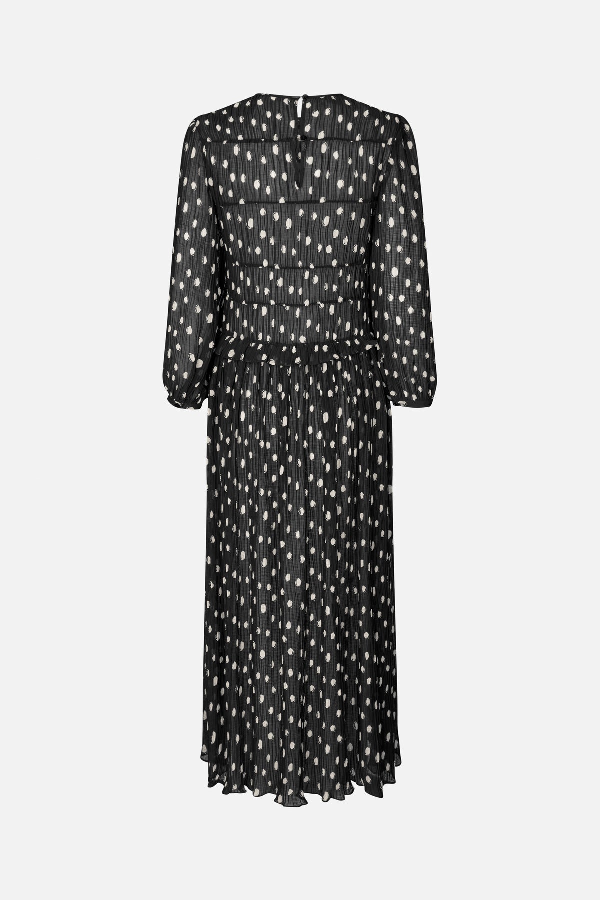 Back view of a sheer black long-sleeved maxi dress with scattered ivory spots, gathered tiers and a button closure.