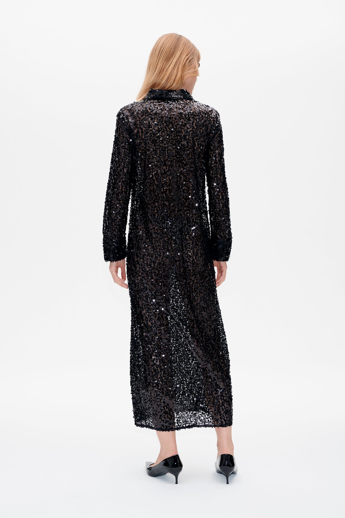 Back view of a long-sleeved black sequin midi dress with a collared neckline and sheer, sparkling fabric.