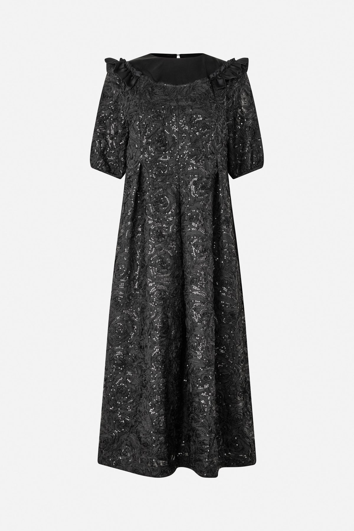 Front view of a long black dress with three-quarter sleeves, shoulder ruffles and an all-over swirling pattern with sequins.