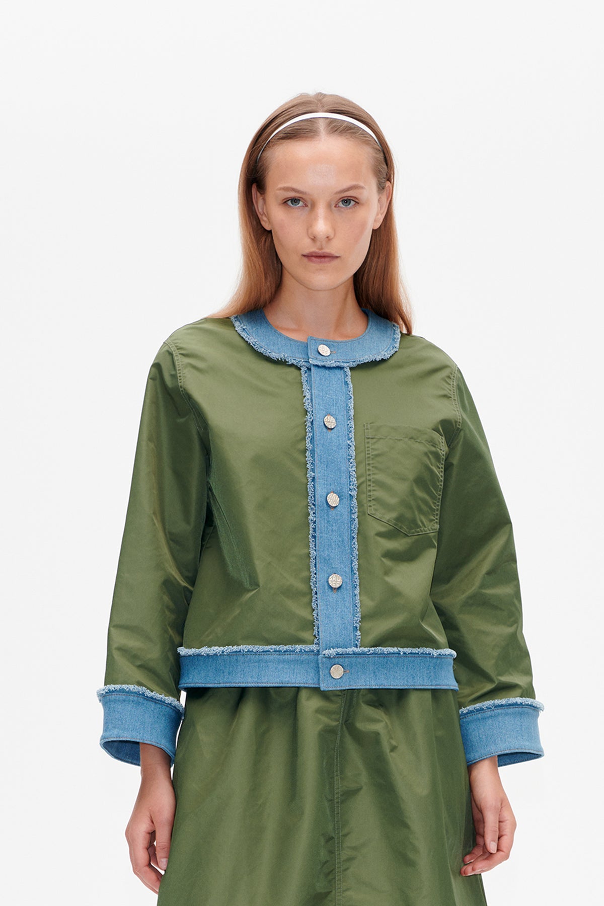 Front view of an olive-green long-sleeved shirt dress with a frayed blue denim collar, button placket, cuffs and waist band.