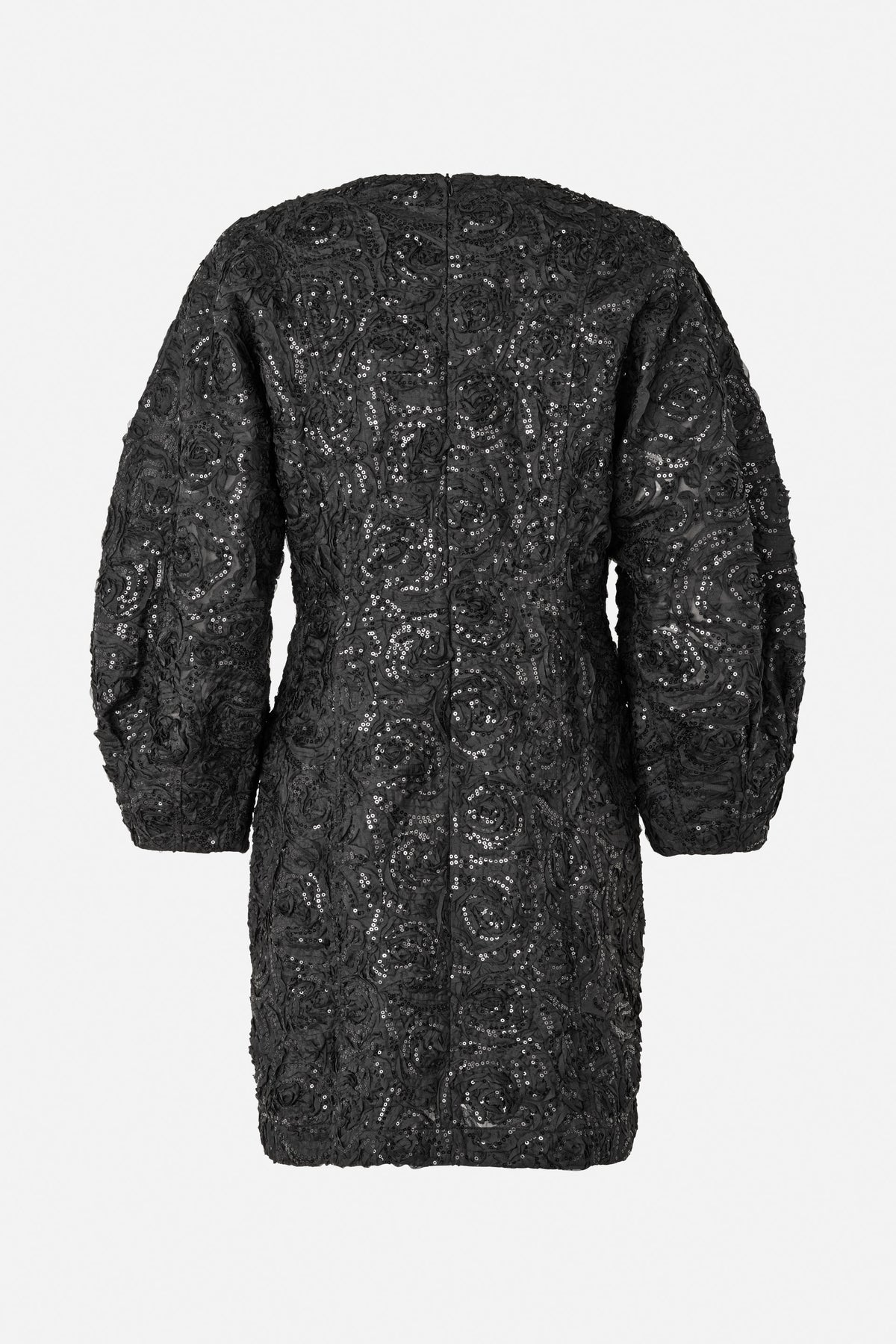 Back view of a black long-sleeved dress with raised swirling floral details and scattered sequins.