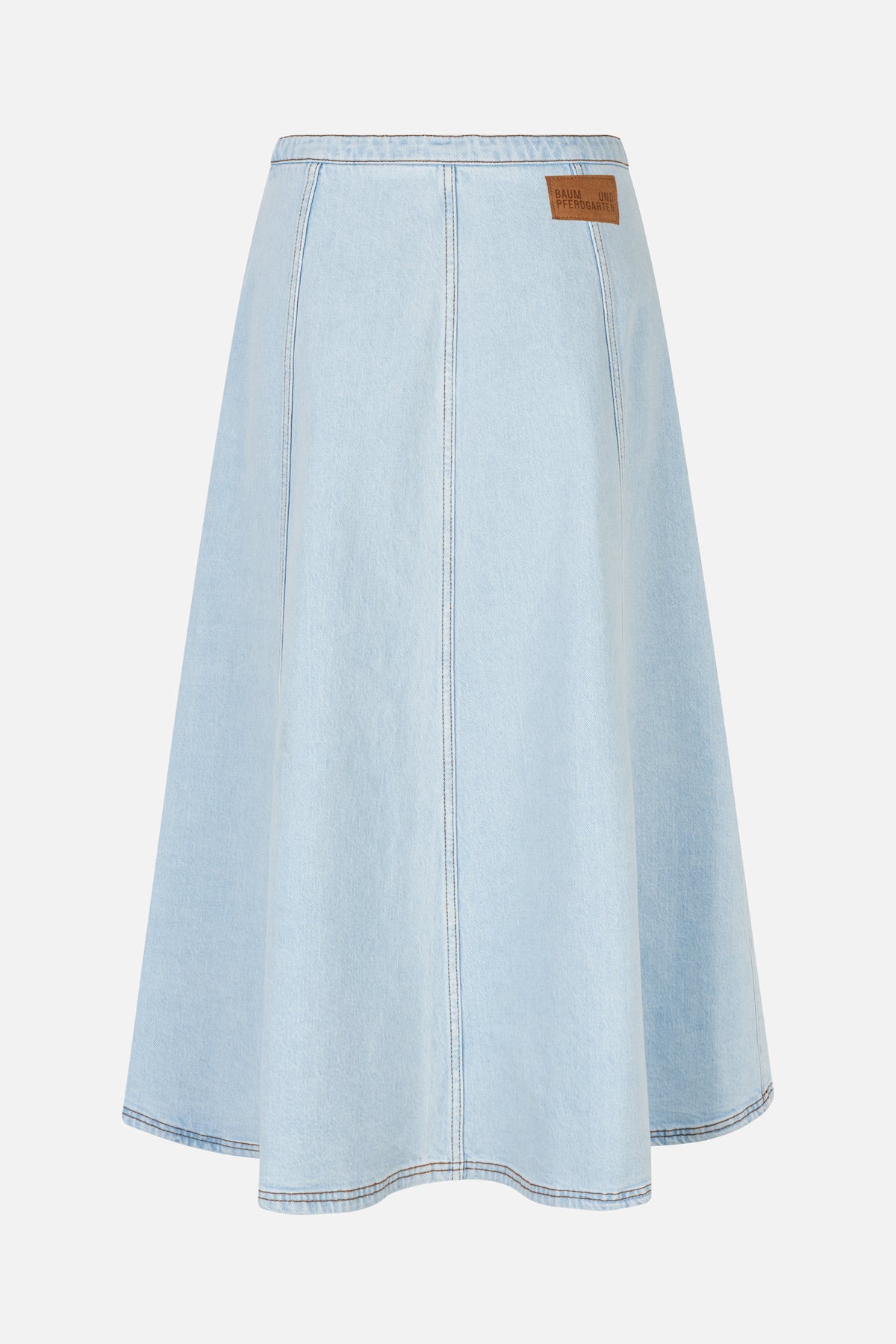 Light-wash denim skirt with a gently flared shape, vertical panel seams and a brown logo patch at the back waistband.