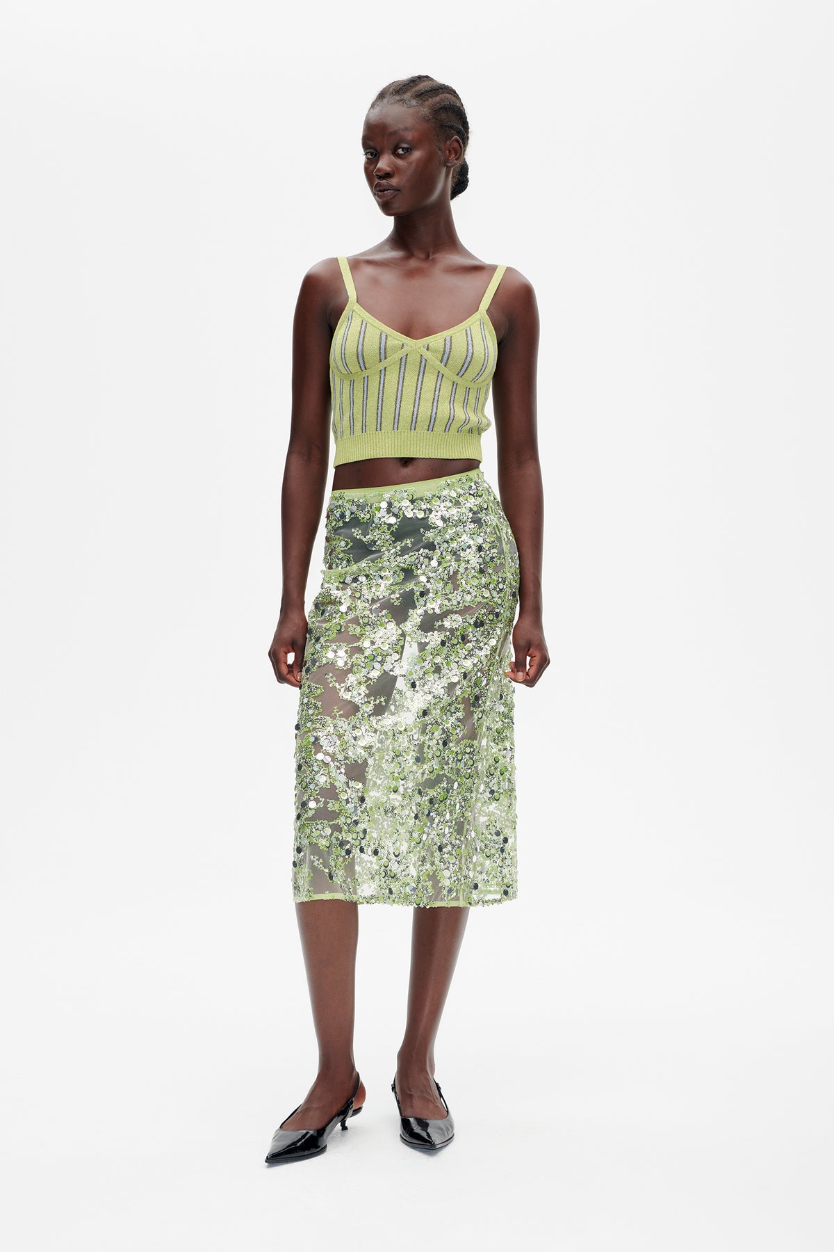 Front view of a lime-green striped knit camisole paired with a sheer midi skirt covered in green and silver sequins.