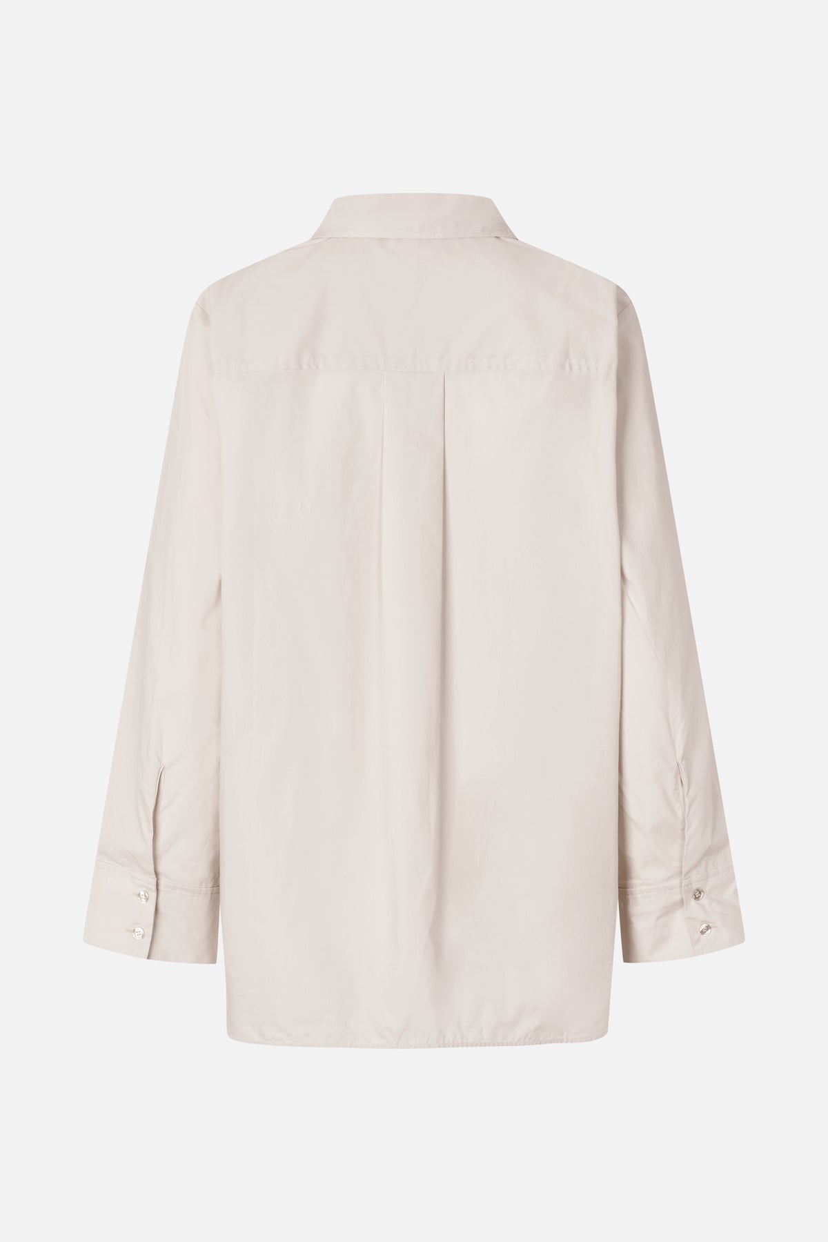 Back view of an oversized ivory shirt with a pointed collar, shoulder yoke, center pleat and buttoned cuffs.