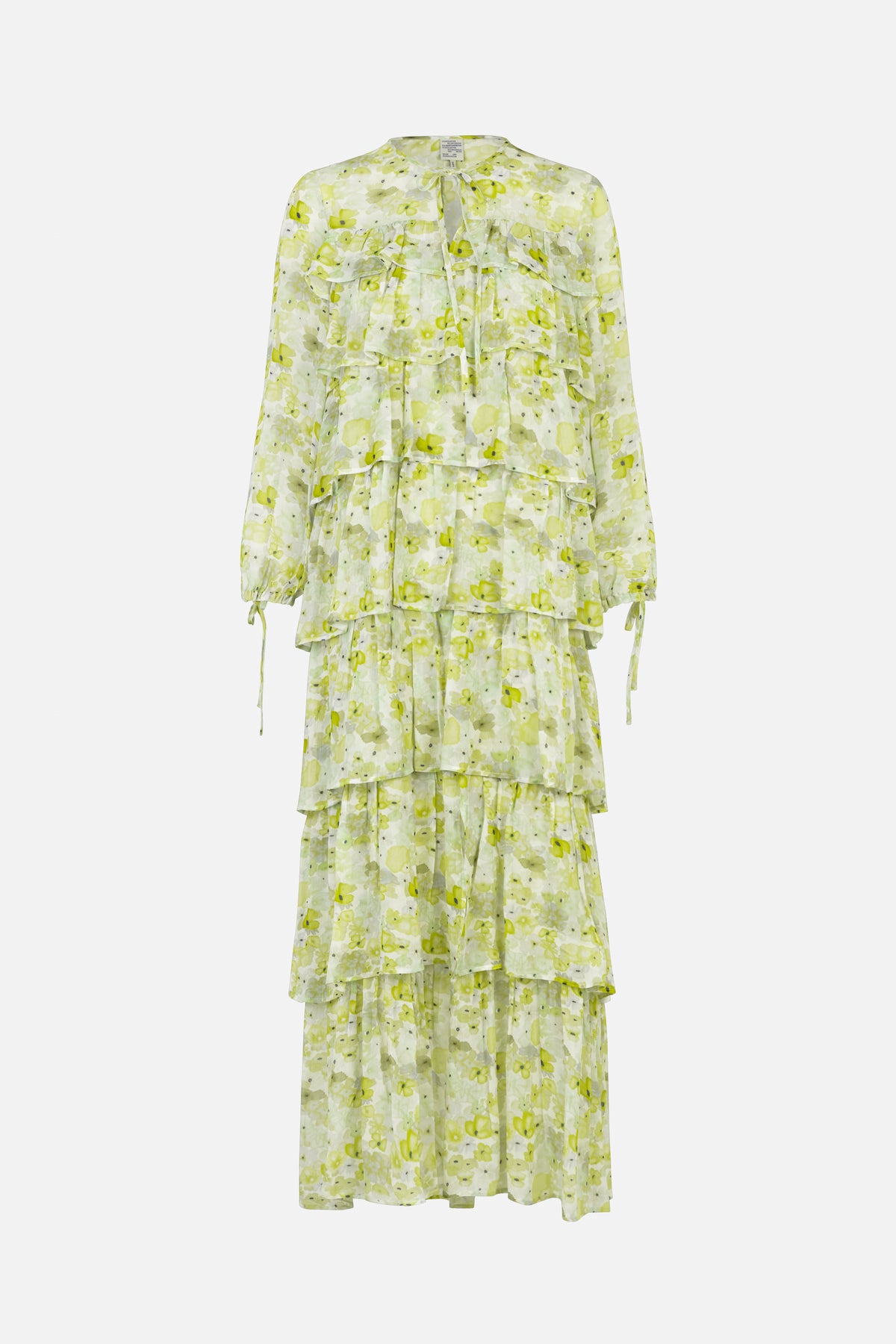 Front view of a long-sleeved, tiered dress with a pale green and white floral print, ruffled panels and a tie neckline.