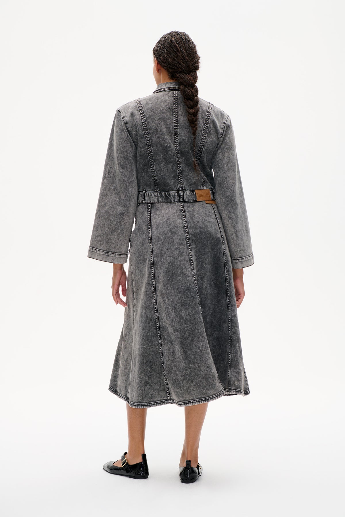 Back view of a grey acid-wash denim shirt dress with long sleeves, contrast stitching and a waist belt.