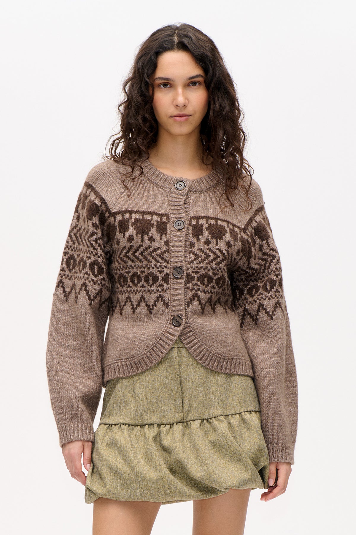 Front view of a model wearing a taupe button-front knit cardigan with dark brown geometric patterned bands and a ribbed round neckline