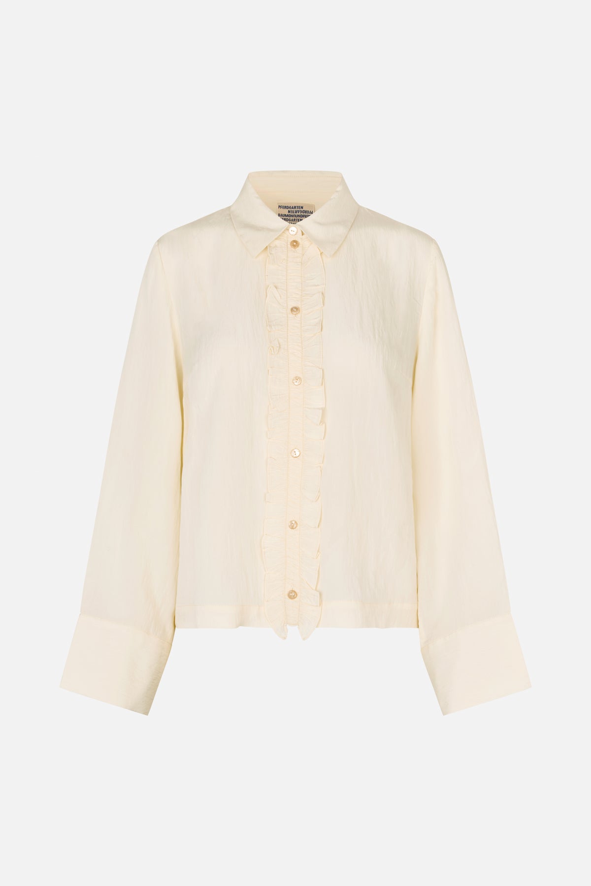 Front view of an ivory long-sleeved button-up blouse with a pointed collar, ruffled placket and wide cuffs.