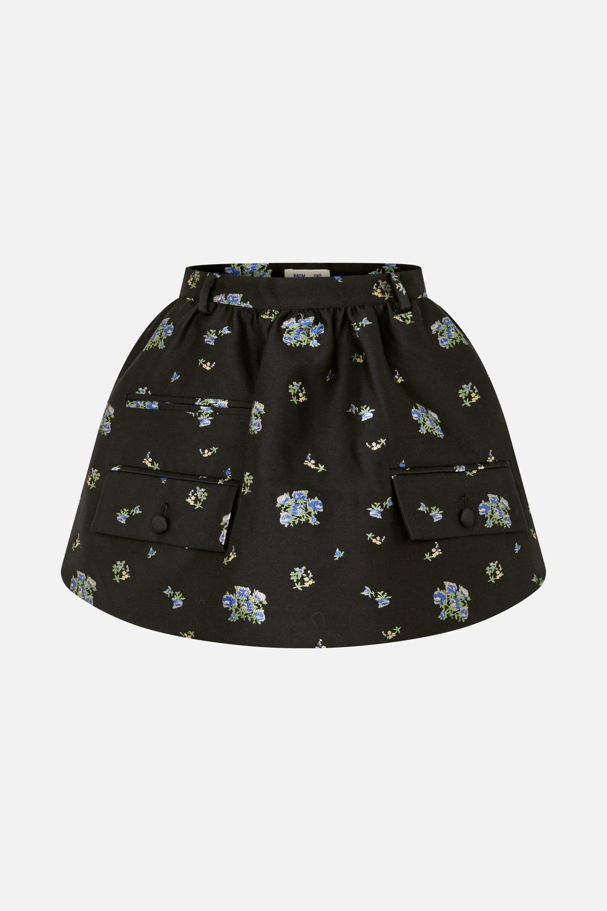 Front view of a black skirt with scattered blue and green floral print, belt loops, and two large buttoned flap pockets.