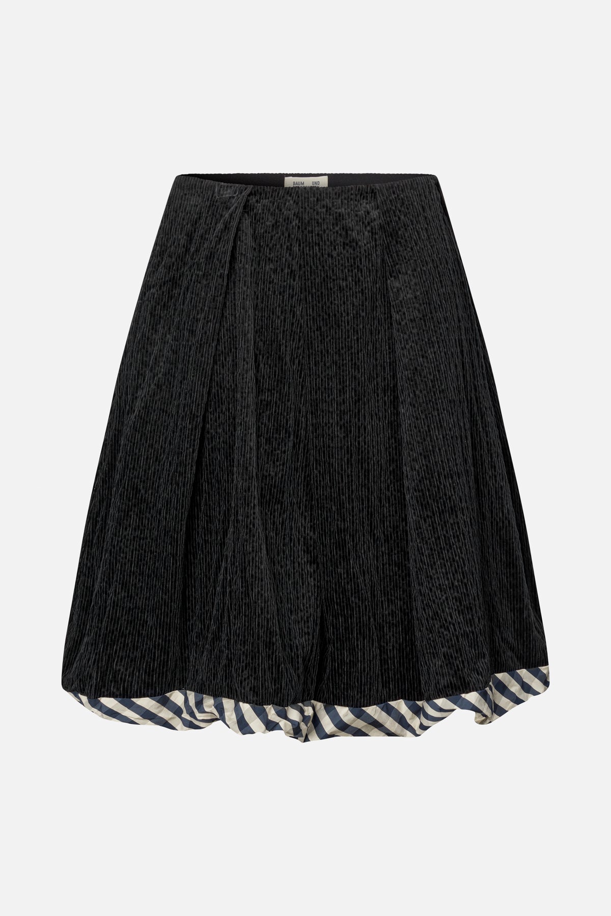 Black corduroy skirt with a blue-and-cream checked ruffle peeking below the hem, shown from the front