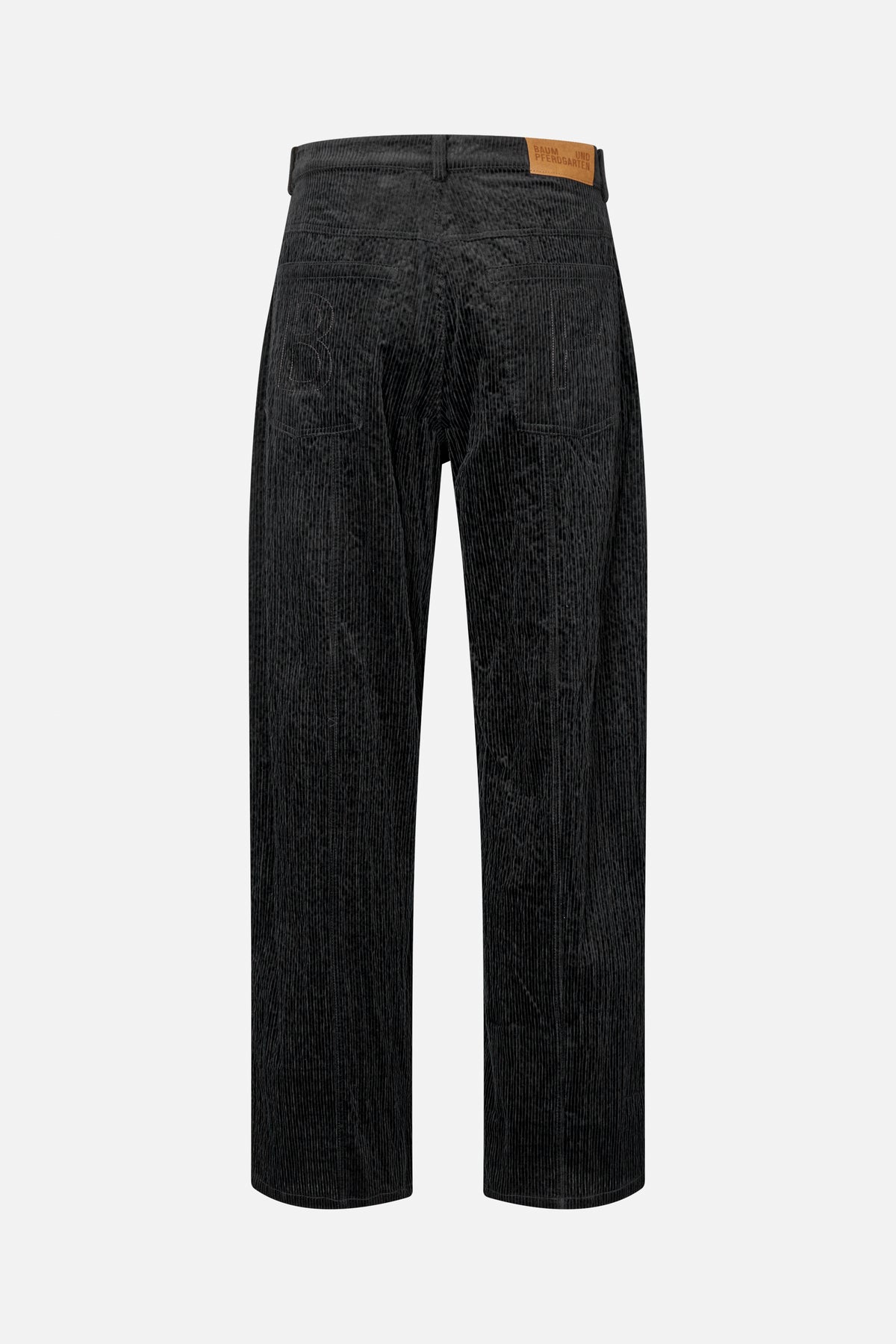 Rückansicht einer schwarzen Cordhose mit geradem Bein, zwei aufgesetzten Taschen und einem hellbraunen Bundetikett.