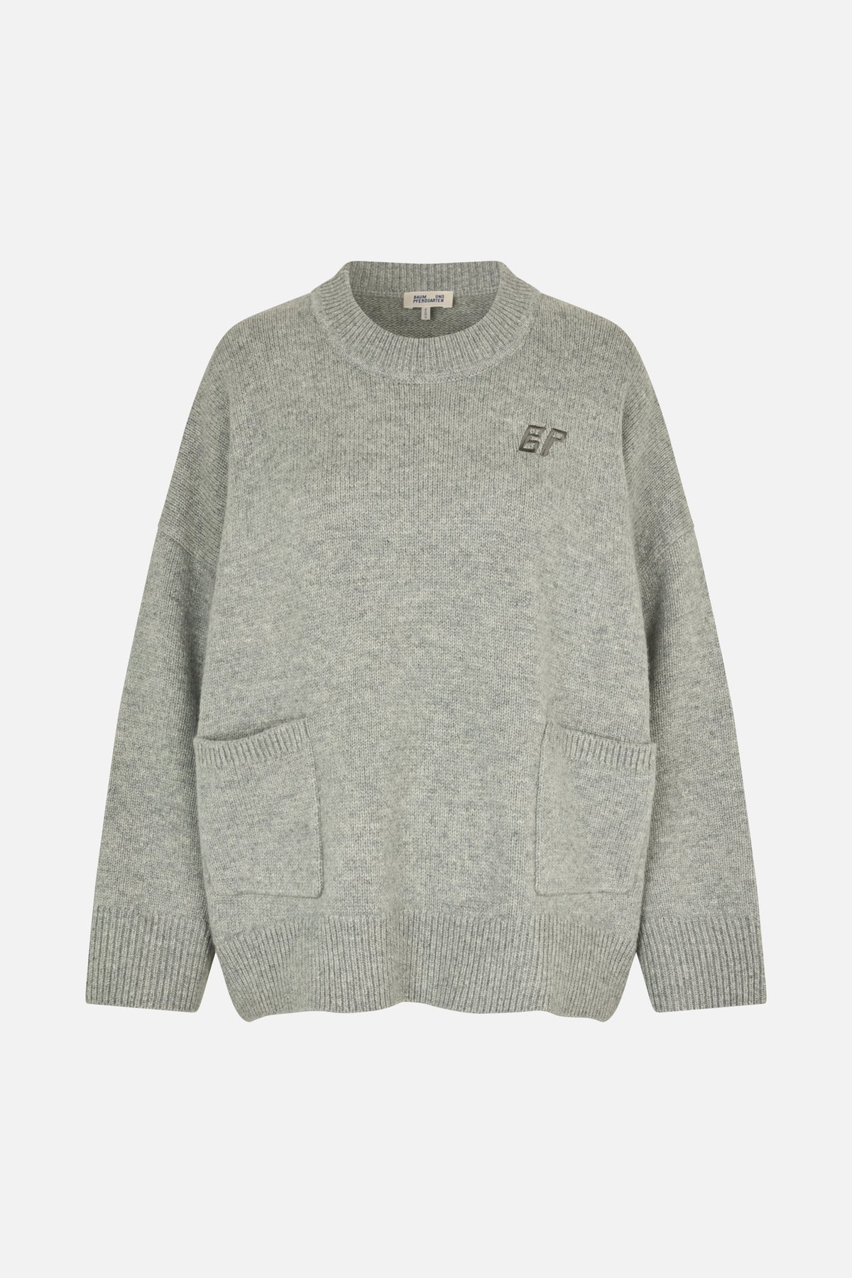 Front view of a grey marl knit sweater with a ribbed crew neck, cuffs and hem, two patch pockets and a small chest monogram.