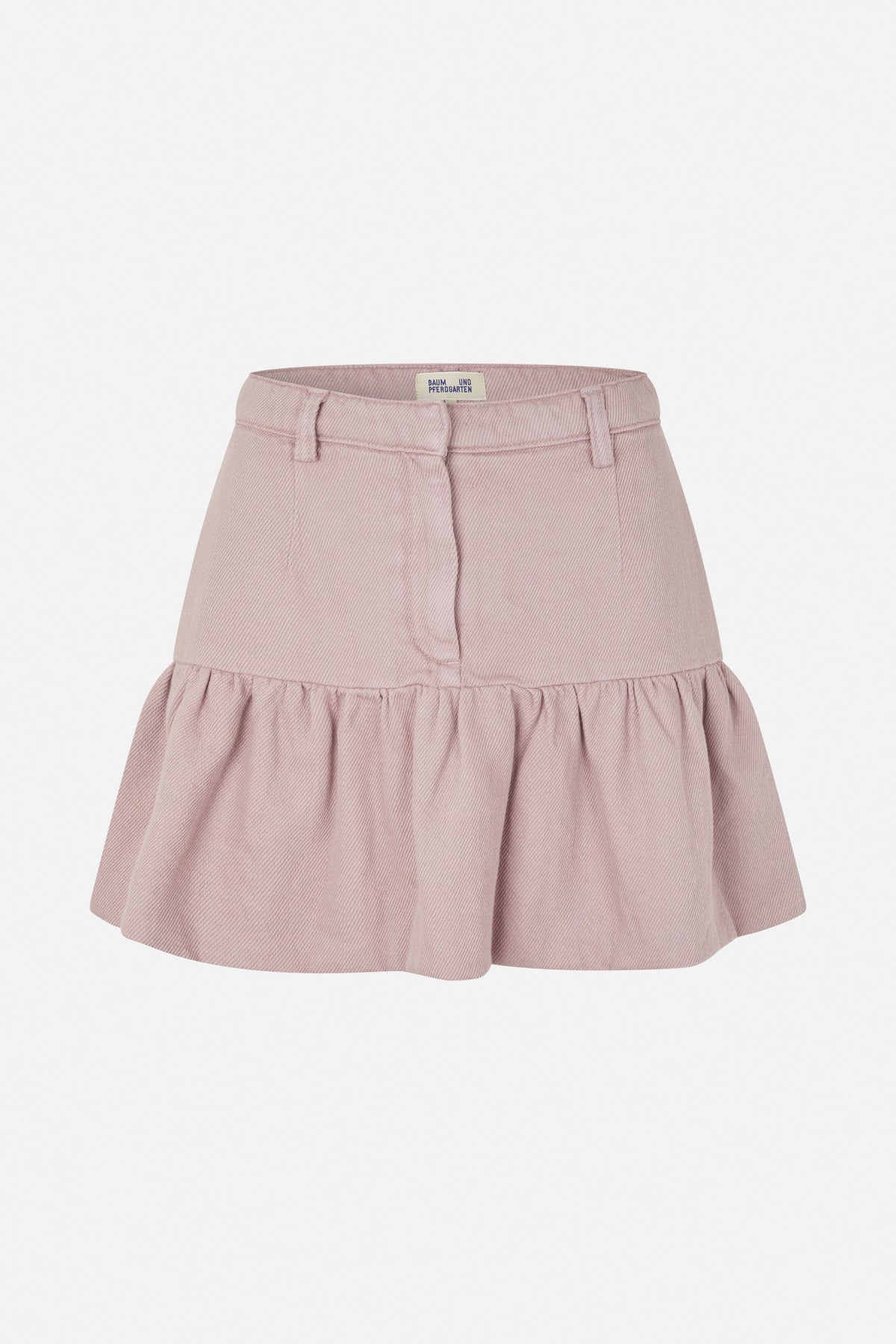 Front view of a dusty pink skirt with belt loops, a zip fly and a gathered flounce hem.