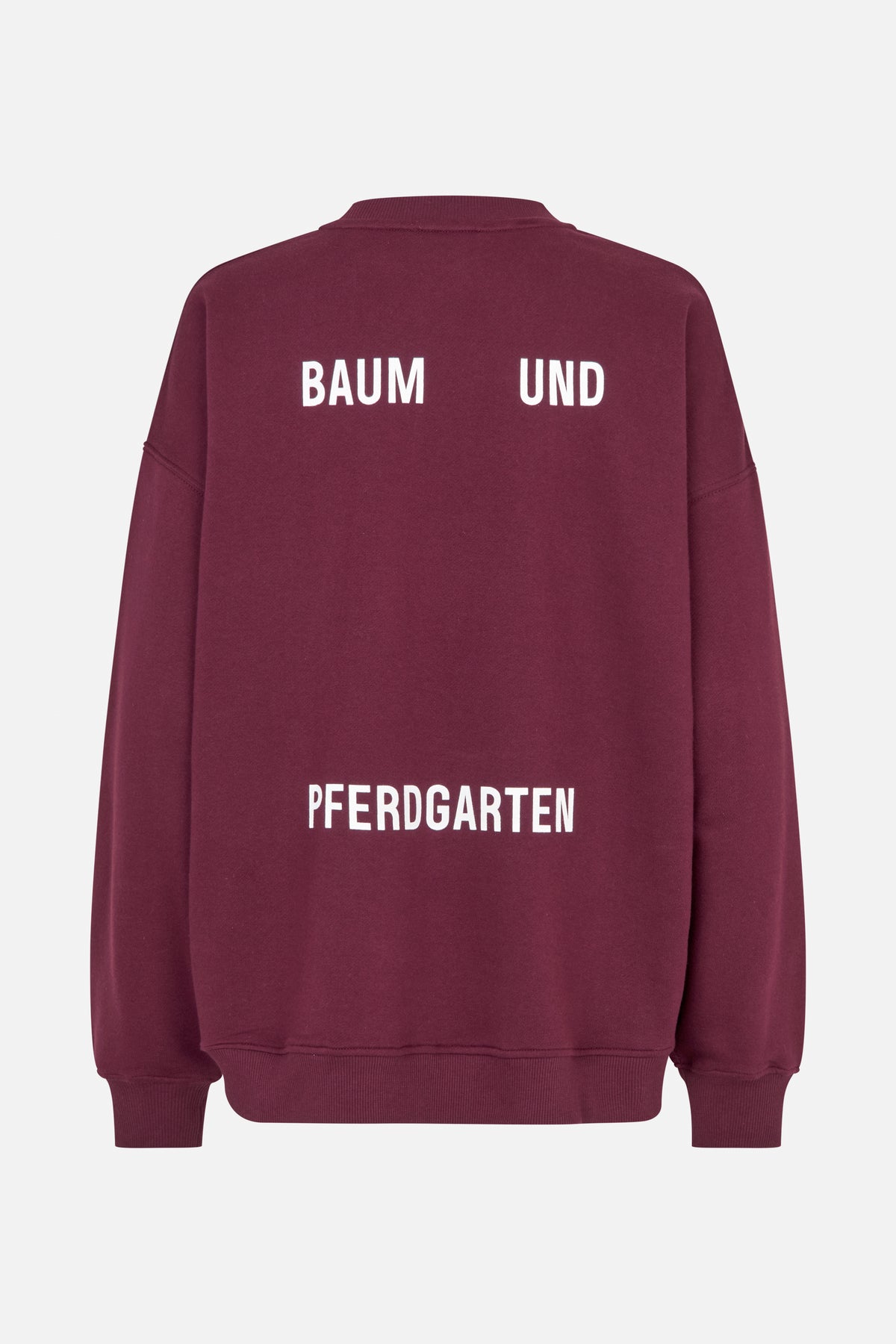 Back view of a burgundy sweatshirt with white Baum und Pferdgarten lettering and ribbed collar, cuffs and hem.