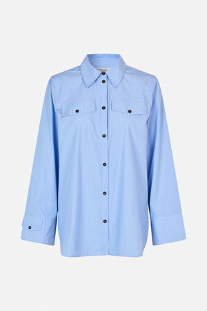 Front view of a light blue shirt with fine white stripes, pointed collar, button front, chest pockets and wide cuffs.