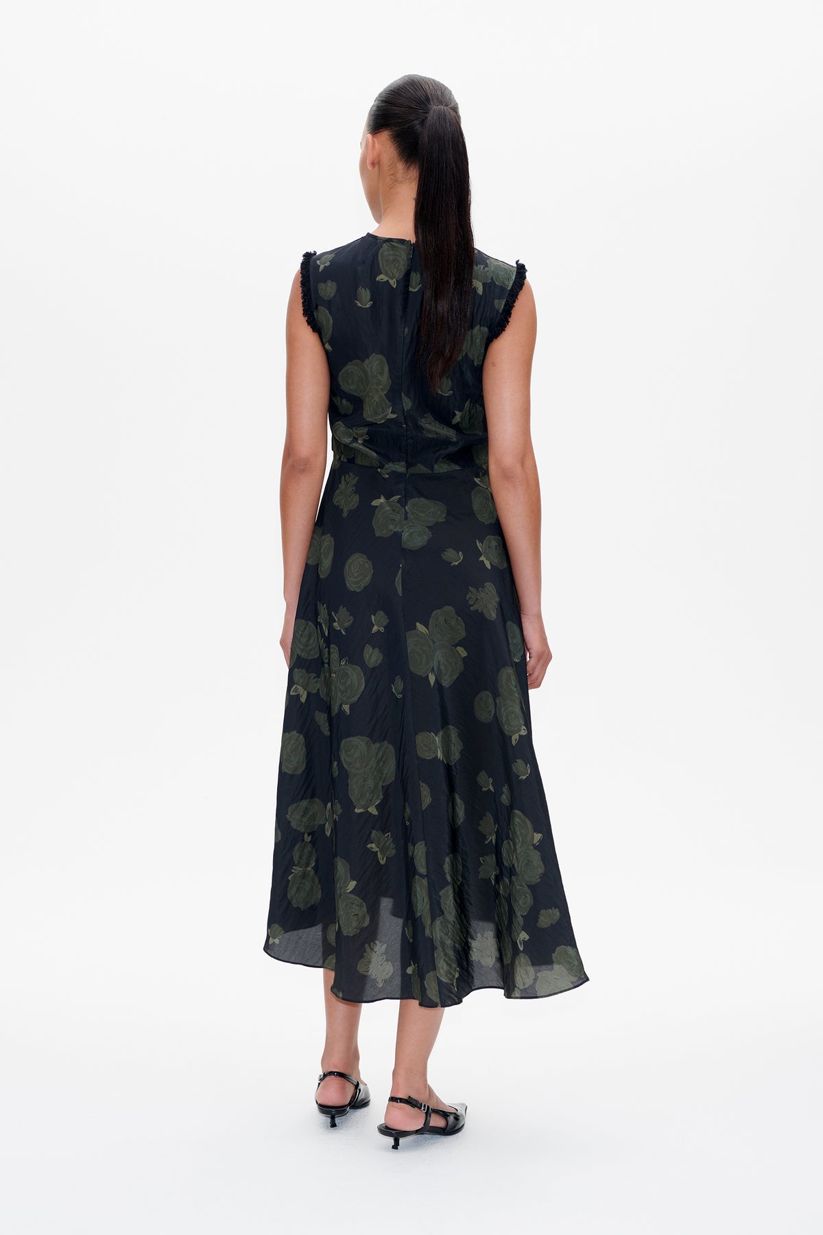 Back view of a dark navy sleeveless midi dress with muted green floral print and frayed shoulder edges.