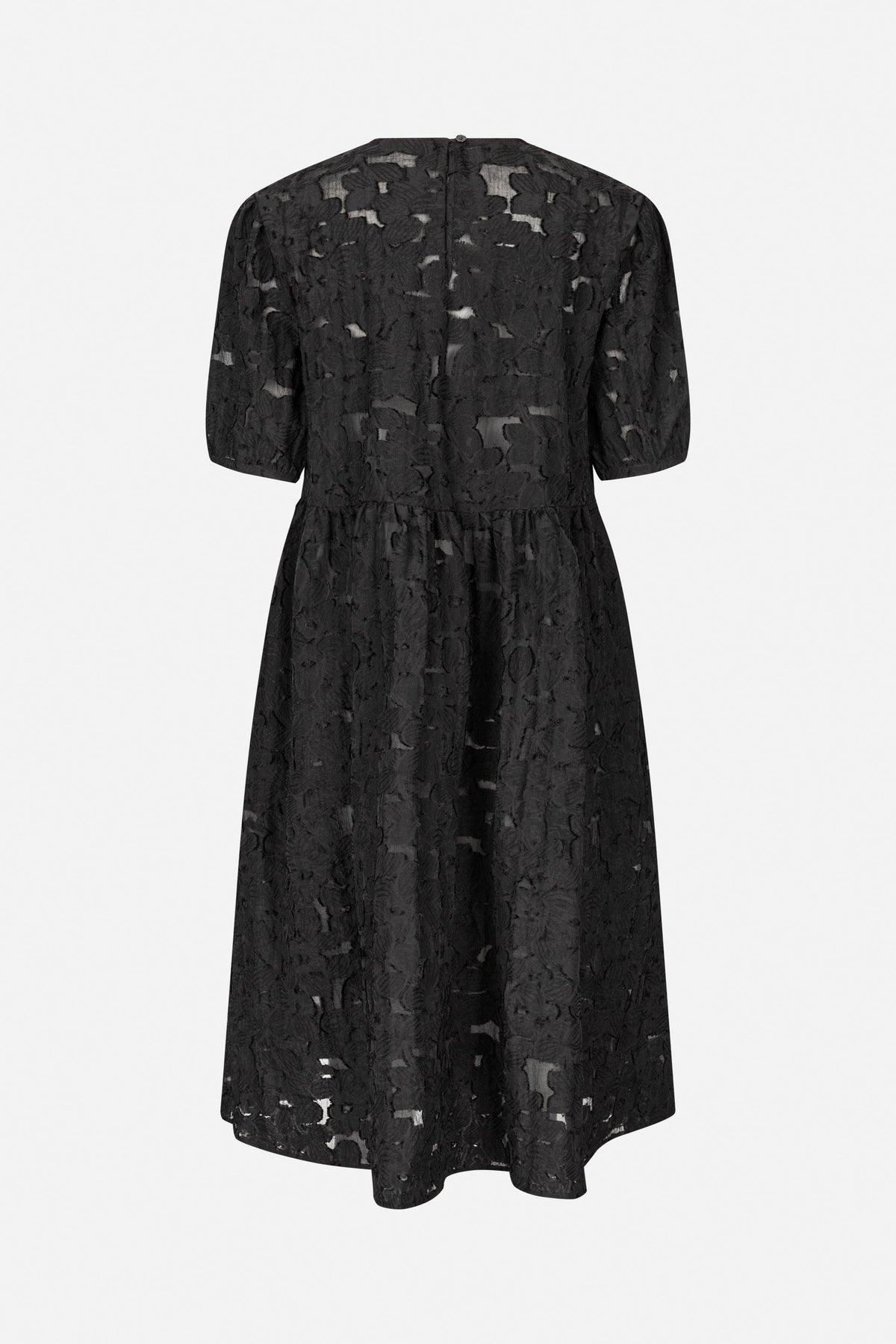 Back view of a black short-sleeved dress with raised floral texture, a gathered waist and a long flared skirt.