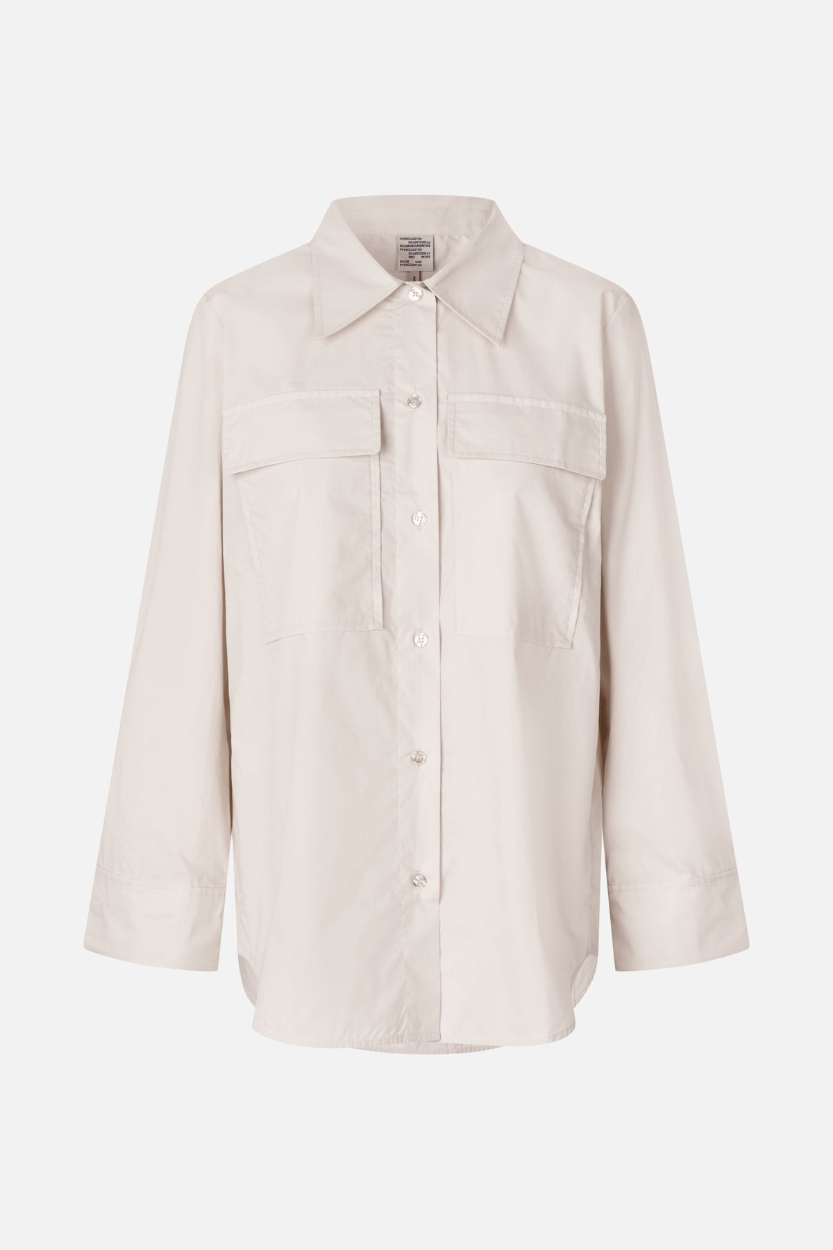 Front view of an ivory long-sleeved button-up shirt with a pointed collar and two large chest pockets.