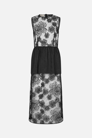 Back view of a sleeveless black dress with sheer floral lace, a gathered opaque waist panel and a lace skirt.