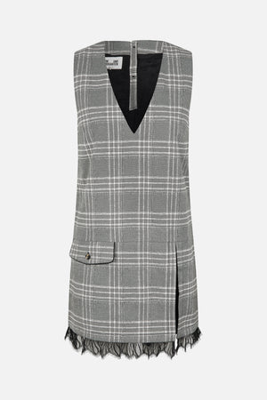 Front view of a sleeveless black, grey and white plaid dress with a deep V-neck, flap pocket and black lace hem.