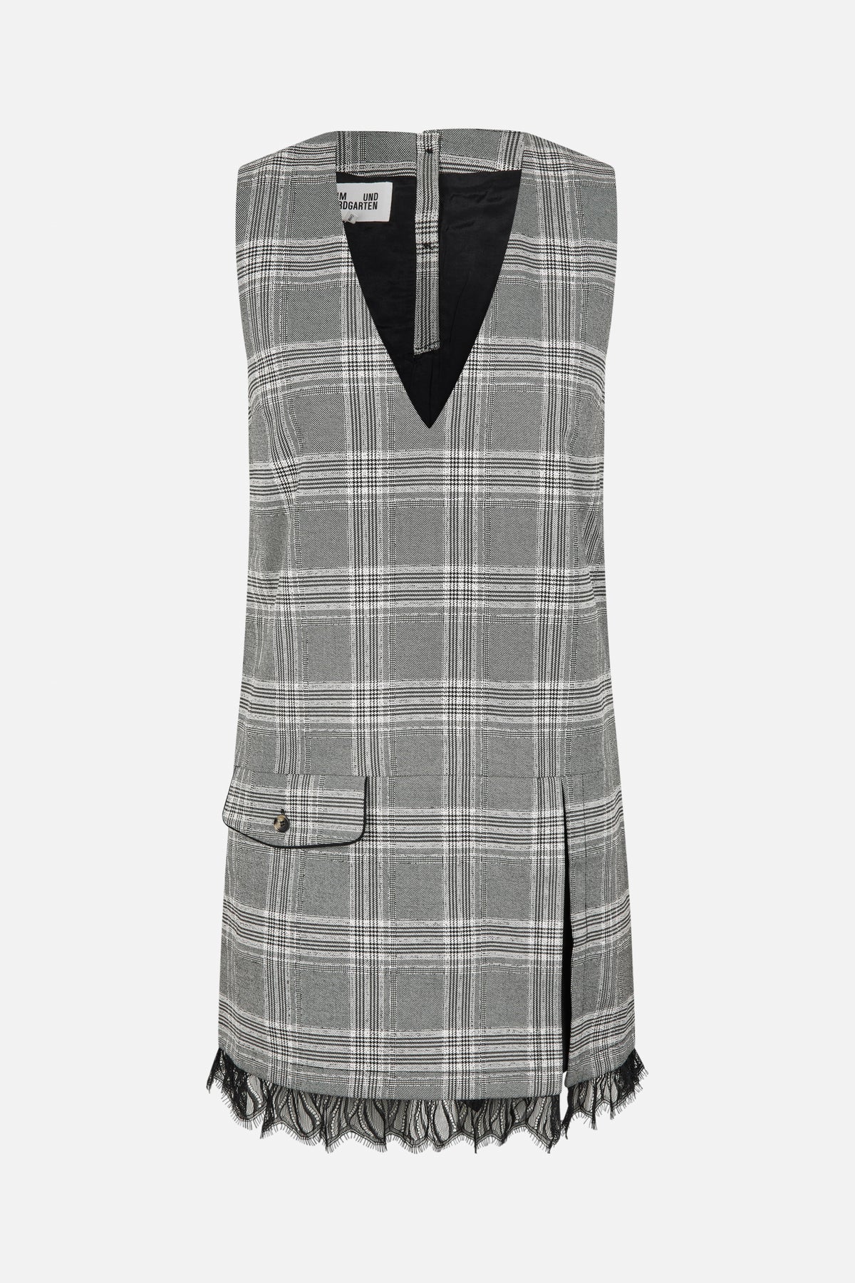 Front view of a sleeveless black, grey and white plaid dress with a deep V-neck, flap pocket and black lace hem.