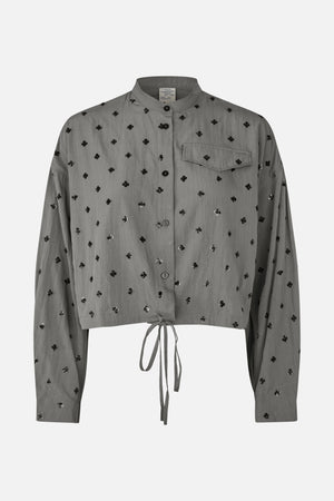 Front view of a grey button-front shirt with a stand collar, chest pocket, black floral embellishments and a tie-front hem.