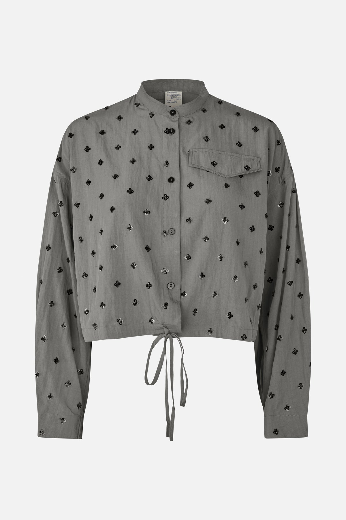 Front view of a grey button-front shirt with a stand collar, chest pocket, black floral embellishments and a tie-front hem.