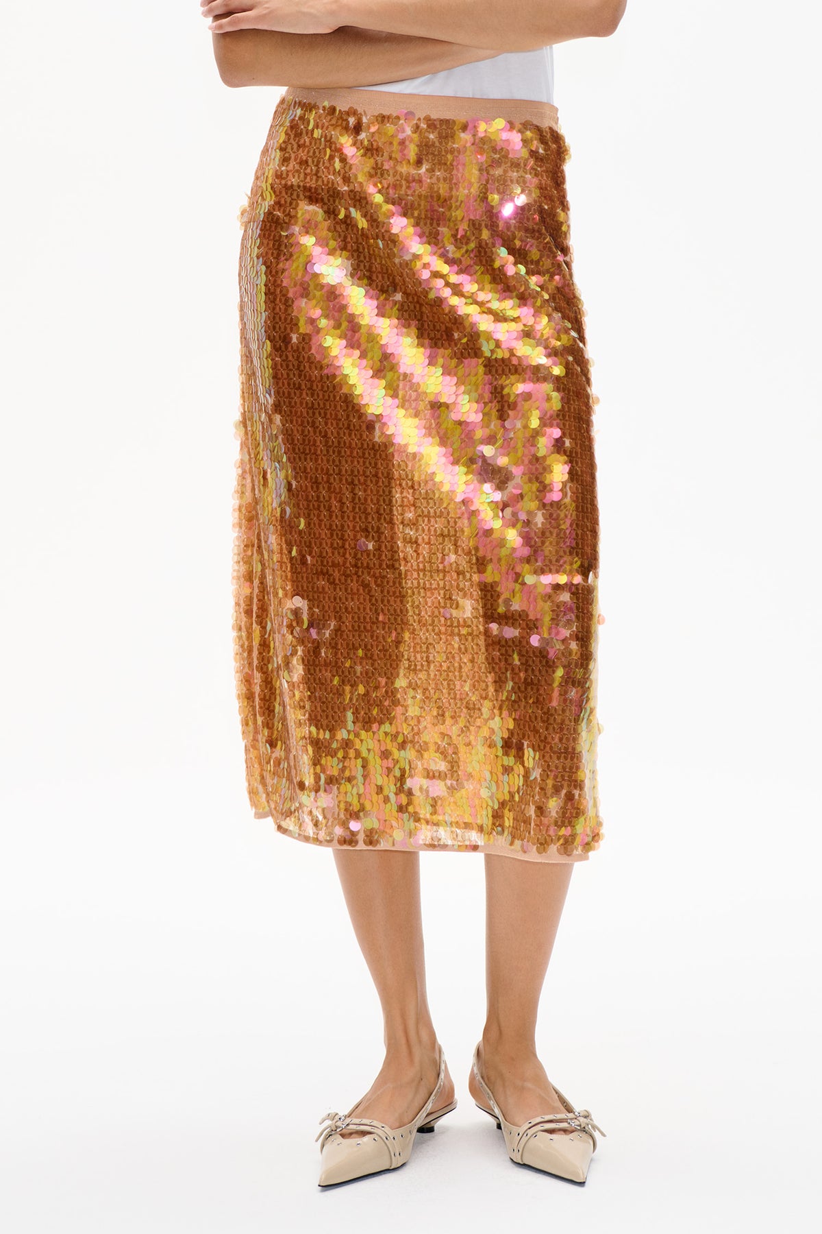 Close-up of a knee-length skirt covered in bronze sequins with iridescent pink, yellow and green accents.