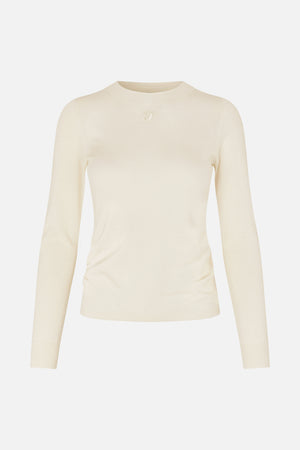 Front view of an ivory fitted long-sleeve knit top with a crew neck and small tonal embroidered chest logo.
