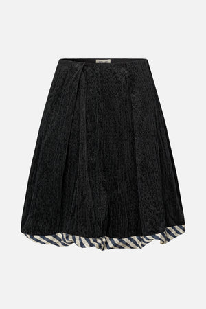 Black corduroy skirt with a blue-and-cream checked ruffle peeking below the hem, shown from the front