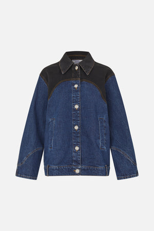 Front view of a blue denim jacket with black contrasting shoulder and chest panels, tan stitching, pointed collar and silver buttons.