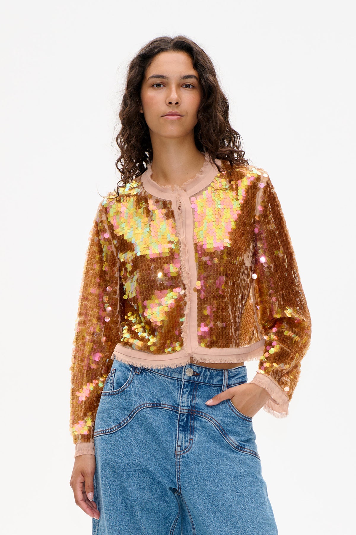 Front view of a cropped jacket covered in bronze, pink and iridescent sequins, with pale pink trim and frayed edges.