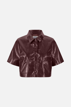 Vorderansicht einer glänzenden bordeauxroten Kurzarmjacke mit spitzem Kragen, verdeckter Knopfleiste und zwei aufgesetzten Taschen.