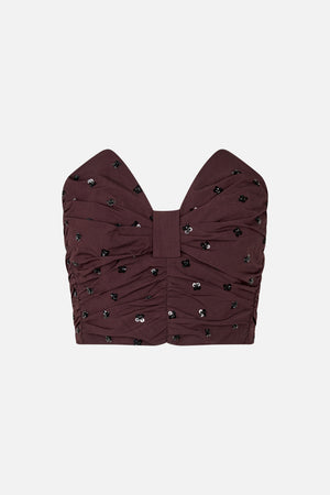Front view of a deep burgundy strapless top with gathered folds and scattered black and silver sequins.