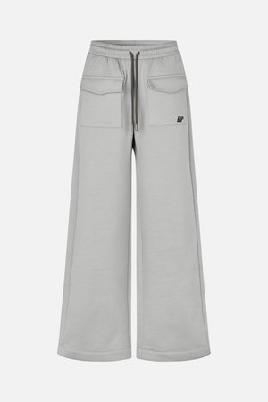 Front view of light grey wide-leg sweatpants with an elastic drawstring waist and large flap pockets.