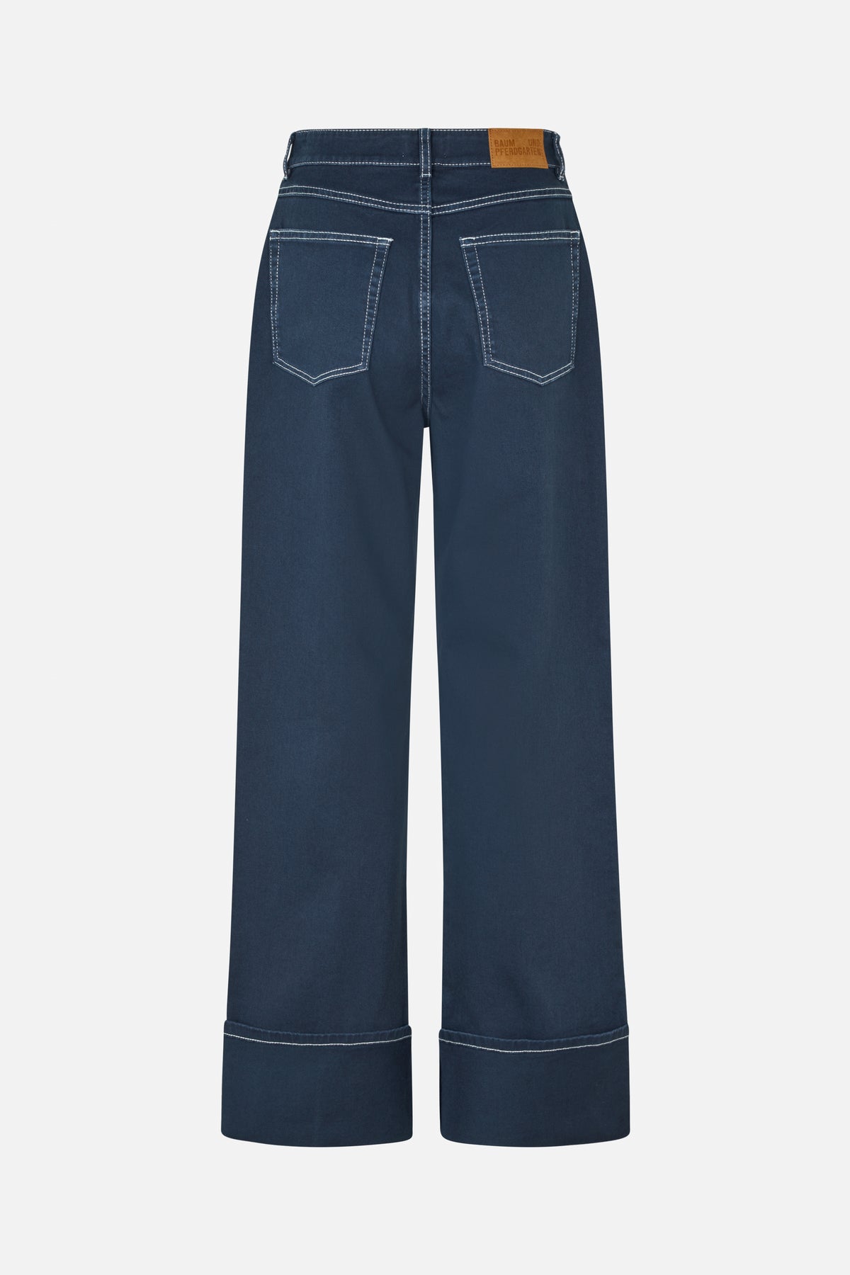 Back view of dark navy wide-leg jeans with white contrast stitching, two back pockets and broad turned-up cuffs.
