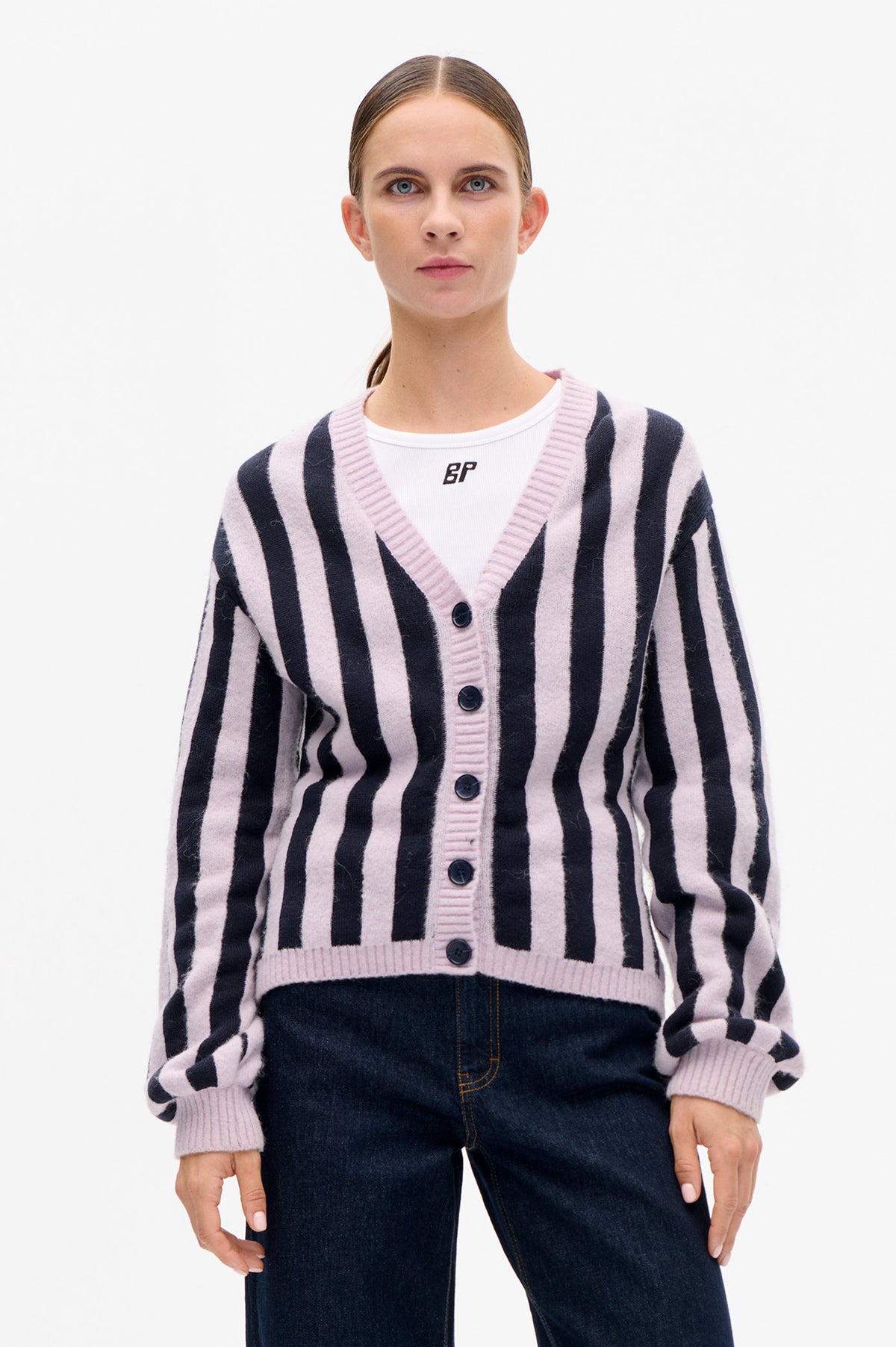 Front view of a pale pink and navy striped button-front cardigan with a ribbed V-neck, worn over a white T-shirt.