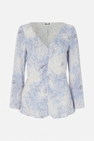 Front view of a long-sleeved blouse with a V-neck, gathered centre front and pale blue, white and grey abstract floral print.