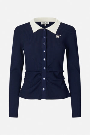 Front view of a navy ribbed cardigan with a white pointed collar, matching buttons and a small embroidered monogram.